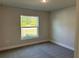 Well-lit bedroom with carpeted floor and window at 8005 Tropicaire Blvd, North Port, FL 34291