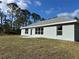 House exterior showcasing rear view and backyard at 8005 Tropicaire Blvd, North Port, FL 34291