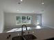 Kitchen with granite countertops, double sink, and a view into the living room at 8005 Tropicaire Blvd, North Port, FL 34291