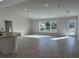 Spacious living area with gray tile floors and large windows providing abundant natural light at 8005 Tropicaire Blvd, North Port, FL 34291