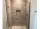 Modern shower with gray tile and glass enclosure at 8005 Tropicaire Blvd, North Port, FL 34291