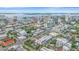 A scenic aerial view captures modern townhomes near the waterfront with city buildings in the distance at 1558 4Th St # 216, Sarasota, FL 34236