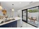 Modern kitchen with island, stainless steel appliances, and patio view at 1558 4Th St # 216, Sarasota, FL 34236