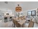Open concept kitchen and dining area with modern appliances and stylish light fixture at 1558 4Th St # 216, Sarasota, FL 34236