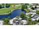Aerial view showcasing home's location in a community near a golf course and lake at 2517 Glebe Farm Close # H-2, Sarasota, FL 34235