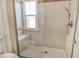 Bathroom with a large walk-in shower and tiled walls at 2517 Glebe Farm Close # H-2, Sarasota, FL 34235