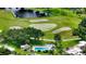 Aerial view of a beautiful golf course with a pond and palm trees at 2517 Glebe Farm Close # H-2, Sarasota, FL 34235