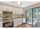 Modern kitchen with stainless steel appliances and granite countertops at 2517 Glebe Farm Close # H-2, Sarasota, FL 34235
