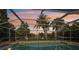 Evening view of the pool area with palm trees and sunset at 1248 Jefferson Dr, Englewood, FL 34224