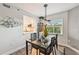 Modern dining room with glass table and four chairs at 1401 S Mccall Rd # 108A, Englewood, FL 34223