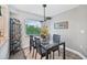 Modern dining room with glass table and four chairs at 1401 S Mccall Rd # 108A, Englewood, FL 34223