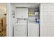 Laundry room with washer, dryer, and storage cabinets at 1401 S Mccall Rd # 108A, Englewood, FL 34223