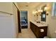 This bathroom has dual sinks, marble countertops, sconce lighting, and a view of the bedroom at 221 Evergreen St, Punta Gorda, FL 33982