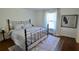 Bright bedroom with iron frame bed, plush bedding, and stylish rug creating a peaceful retreat at 221 Evergreen St, Punta Gorda, FL 33982