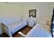 Twin bedroom features two beds with striped bedding, stylish lamps, and hardwood floors at 221 Evergreen St, Punta Gorda, FL 33982