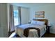 Bright bedroom with a comfortable bed, stylish decor, and a sunlit window at 221 Evergreen St, Punta Gorda, FL 33982