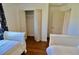 Spacious twin bedroom featuring a closet and a window with blue floral curtains at 221 Evergreen St, Punta Gorda, FL 33982