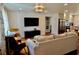 Open-concept living room leading to the kitchen, featuring modern lighting and a comfortable seating area at 221 Evergreen St, Punta Gorda, FL 33982