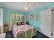 Bright bedroom with colorful decor, a patterned bedspread, and natural light from the window at 839 40Th St, Sarasota, FL 34234