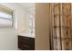 Modern bathroom with dark vanity, shower, and single window at 2216 Lee Ln, Sarasota, FL 34231