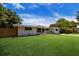 Ranch style home with a well-manicured lawn and wood fence at 2216 Lee Ln, Sarasota, FL 34231