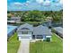 Aerial view of canal-front home with lush landscaping and two-car garage at 5111 Coral Blvd, Bradenton, FL 34210