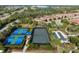 Aerial view showcases tennis courts, pickleball courts, and shuffleboard courts, surrounded by lush landscaping at 5709 Puccini St, Nokomis, FL 34275