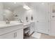 Bright bathroom with double vanity, white cabinets, and a walk-in shower at 5709 Puccini St, Nokomis, FL 34275