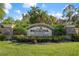 Beautifully landscaped entrance to the Bellacina community by Casey Key, featuring stone signage and vibrant flower beds at 5709 Puccini St, Nokomis, FL 34275