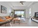 Inviting living room with tile flooring, neutral colors, and view of the outdoor area at 5709 Puccini St, Nokomis, FL 34275