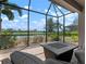 Relaxing screened patio features a fire pit and stunning views of the lake and mature landscaping at 5709 Puccini St, Nokomis, FL 34275