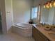 Bathroom with double vanity, corner soaking tub, and shower at 5116 Brooksbend Cir, Sarasota, FL 34238