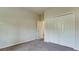 Guest bedroom with neutral walls, carpeting, and a double door closet at 5116 Brooksbend Cir, Sarasota, FL 34238
