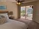 Main bedroom with access to the backyard patio and screened lanai at 5116 Brooksbend Cir, Sarasota, FL 34238