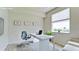 Virtually staged home office features a desk, chair, and large window at 5116 Brooksbend Cir, Sarasota, FL 34238