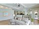 Bright living room features hardwood floors and an open floor plan leading to the kitchen at 5116 Brooksbend Cir, Sarasota, FL 34238