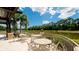 Relaxing patio area with tables and chairs overlooking a pond at 5116 Brooksbend Cir, Sarasota, FL 34238