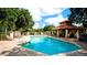 Community pool with a tiled deck and shaded seating at 5116 Brooksbend Cir, Sarasota, FL 34238