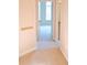 Hallway with carpet, neutral walls, and doors to bedrooms and bathroom at 1201 Bensbrooke Dr, Wesley Chapel, FL 33543