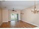 Spacious living room with wood-look floors and sliding glass doors at 1201 Bensbrooke Dr, Wesley Chapel, FL 33543