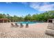 Community pool with lounge chairs and umbrellas at 1201 Bensbrooke Dr, Wesley Chapel, FL 33543