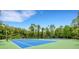 Two tennis courts with blue surface and green perimeter at 1201 Bensbrooke Dr, Wesley Chapel, FL 33543