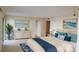 Main bedroom with dresser, king-size bed, and coastal art at 2232 Bahia Vista St # A2, Sarasota, FL 34239