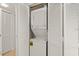 A laundry closet with white, stacked washer and dryer with louvered closet doors at 2232 Bahia Vista St # A2, Sarasota, FL 34239