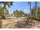 Community pool with mature landscaping and lounge chairs on a brick-paved deck at 2232 Bahia Vista St # A2, Sarasota, FL 34239