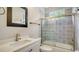 Beautiful bathroom with decorative tile surround, glass shower door, and granite-topped vanity at 7217 Churston Ln, University Park, FL 34201