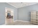 Light and airy bedroom with a ceiling fan and decorative bookcase, as seen from the doorway at 7217 Churston Ln, University Park, FL 34201