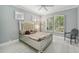 Comfortable bedroom with plantation shutters, a decorative bed frame, and neutral-colored walls at 7217 Churston Ln, University Park, FL 34201