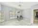 Light and airy bedroom with a ceiling fan, decorative lighting, and a decorative bookcase at 7217 Churston Ln, University Park, FL 34201