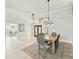 Open dining area featuring a modern chandelier and views of the entryway and living area at 7217 Churston Ln, University Park, FL 34201